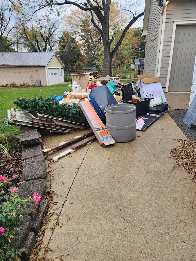 Dumpster being loaded with debris for Residential Dumpster Rental in Granby